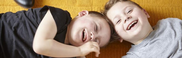 Brothers on floor playing